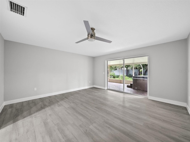 spare room featuring ceiling fan and hardwood / wood-style flooring