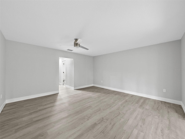 empty room featuring ceiling fan and light hardwood / wood-style flooring