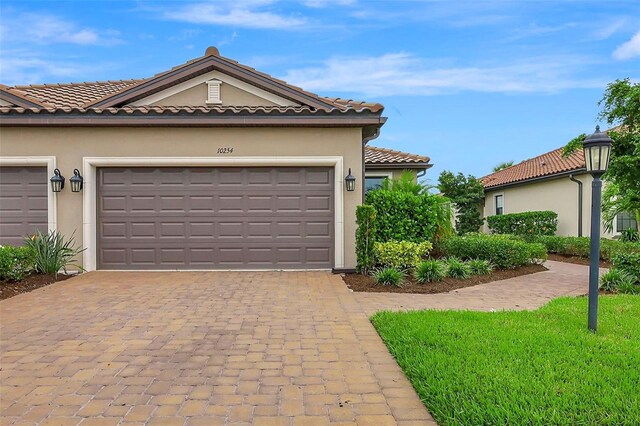 view of front of property with a front yard and a garage