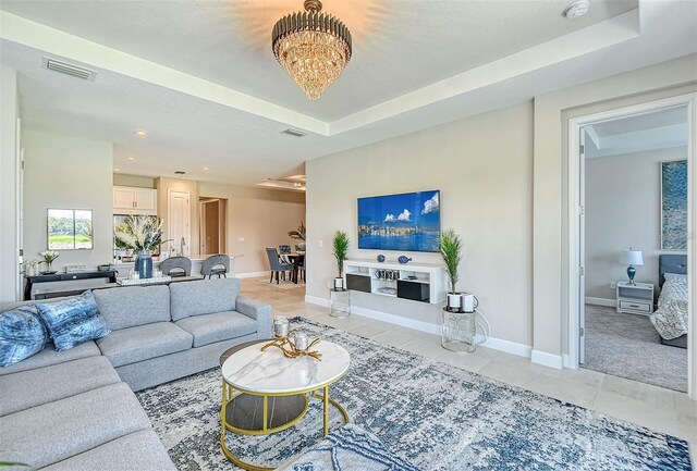 tiled living room featuring a raised ceiling