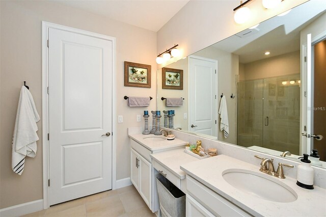 bathroom featuring vanity, tile patterned flooring, a skylight, and an enclosed shower