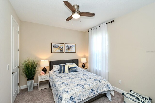 bedroom featuring light carpet and ceiling fan