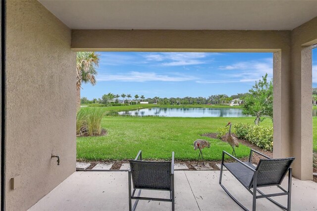 view of patio with a water view