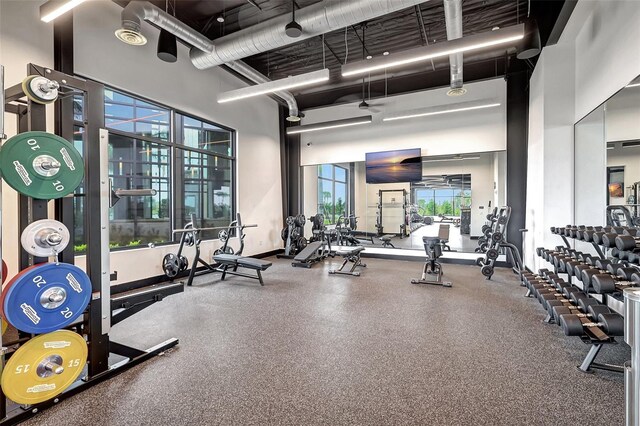 exercise room with a towering ceiling