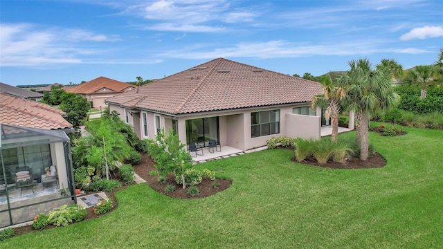 rear view of house with a yard and a patio area