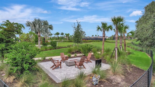 view of yard featuring a fire pit and a patio area