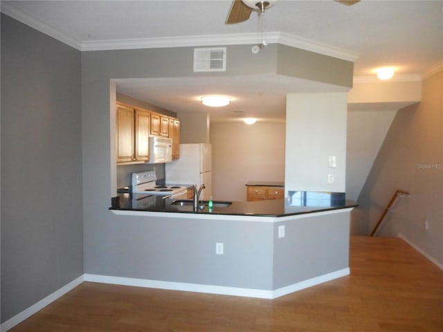 kitchen with light brown cabinetry, white appliances, crown molding, sink, and wood-type flooring