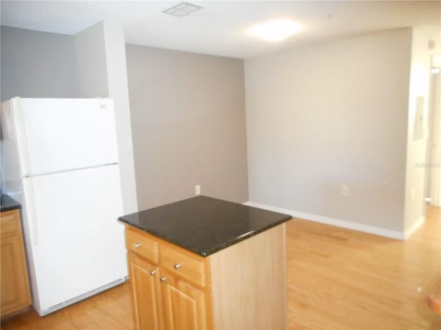 kitchen with white fridge and light hardwood / wood-style floors