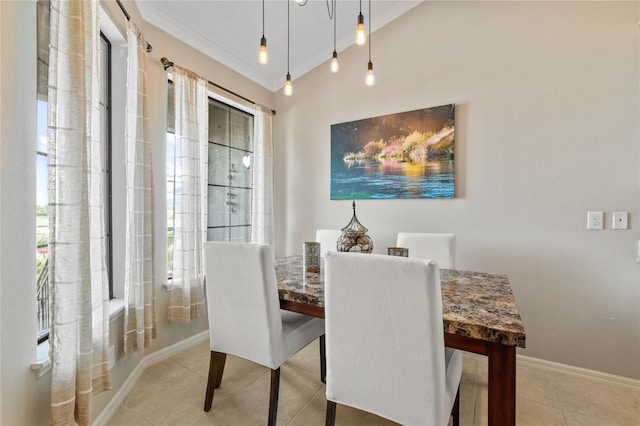 tiled dining space with a wealth of natural light and ornamental molding