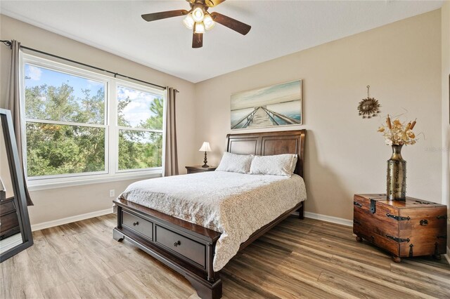 bedroom with ceiling fan and light hardwood / wood-style flooring