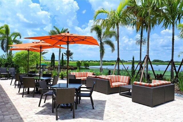 view of patio / terrace with a water view and outdoor lounge area