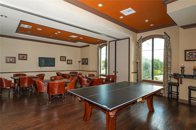 recreation room featuring ornamental molding and dark hardwood / wood-style floors