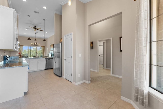 kitchen featuring stainless steel appliances, white cabinetry, a sink, and visible vents