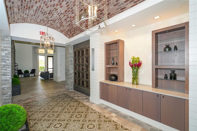 hall featuring brick ceiling, vaulted ceiling, a chandelier, and recessed lighting