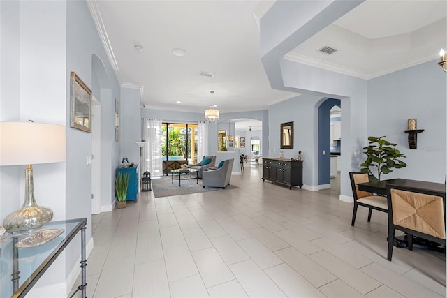 living room featuring light tile patterned floors, an inviting chandelier, and ornamental molding