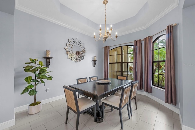 dining space with a raised ceiling, light tile patterned floors, crown molding, and an inviting chandelier