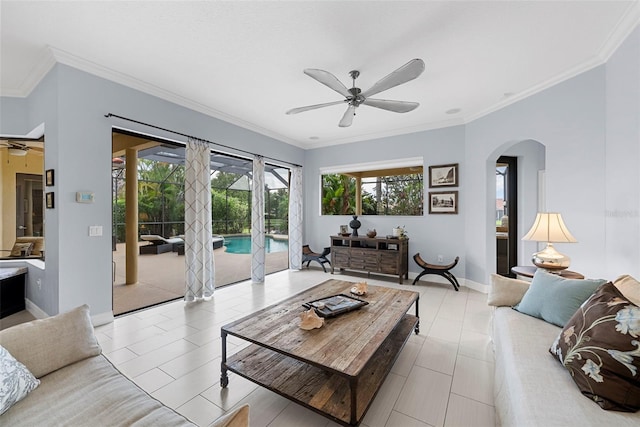 tiled living room with ceiling fan and ornamental molding