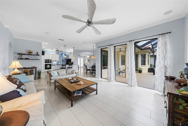 living room featuring crown molding, light tile patterned floors, and ceiling fan with notable chandelier