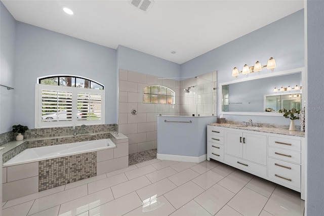 bathroom featuring tile patterned flooring, vanity, and separate shower and tub