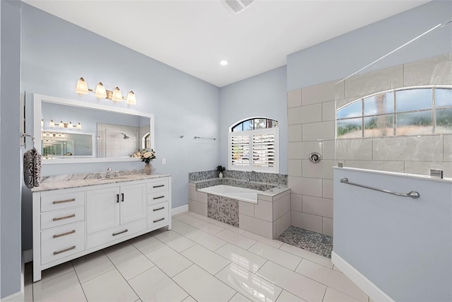 bathroom with tile patterned flooring, shower with separate bathtub, and vanity