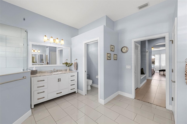 bathroom featuring tile patterned floors, vanity, and toilet