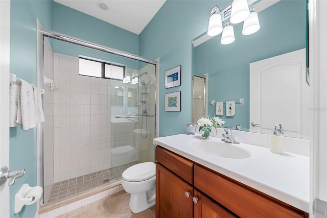 bathroom featuring tile patterned flooring, vanity, an enclosed shower, and toilet