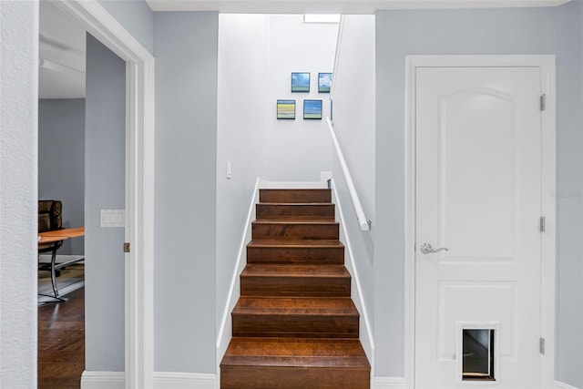 stairs featuring hardwood / wood-style floors