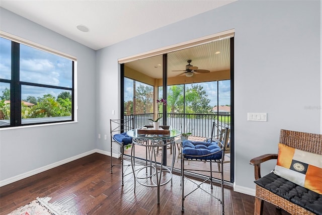 dining space with ceiling fan, dark wood-type flooring, and a wealth of natural light