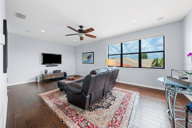 living room featuring dark hardwood / wood-style floors and ceiling fan