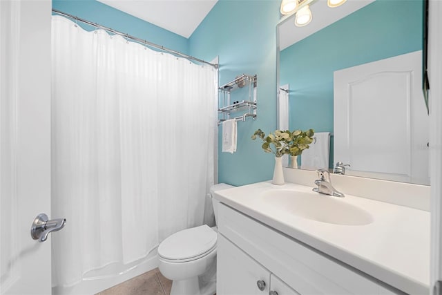 bathroom with tile patterned flooring, vanity, and toilet