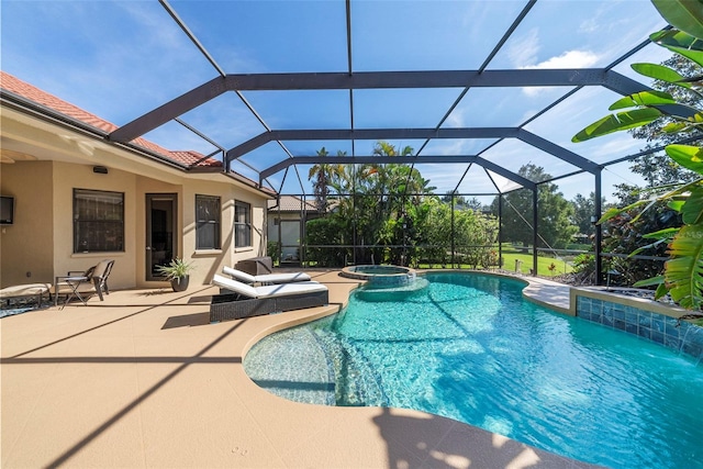 view of swimming pool featuring glass enclosure, an in ground hot tub, and a patio area