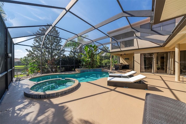 view of pool featuring an in ground hot tub, a patio, and a lanai