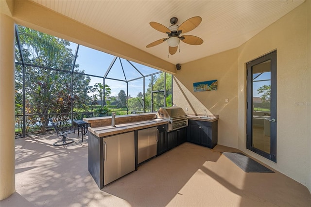 view of patio featuring an outdoor bar, ceiling fan, a lanai, a grill, and exterior kitchen