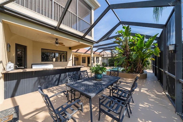 view of patio with a lanai, ceiling fan, a balcony, and a swimming pool