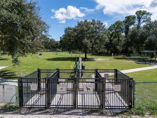 view of gate with a lawn