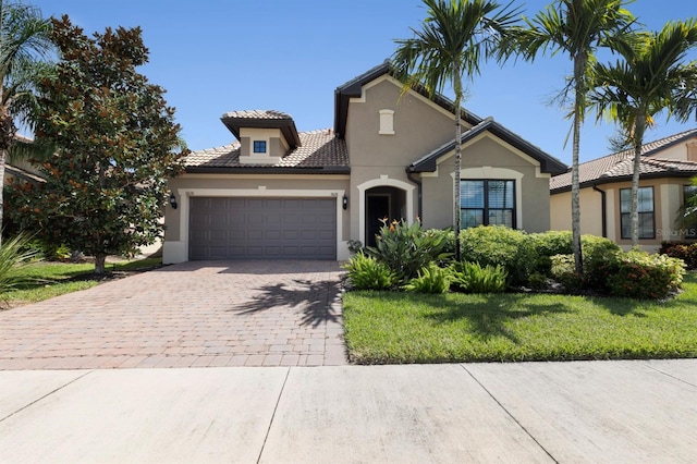 view of front of house with a garage and a front lawn