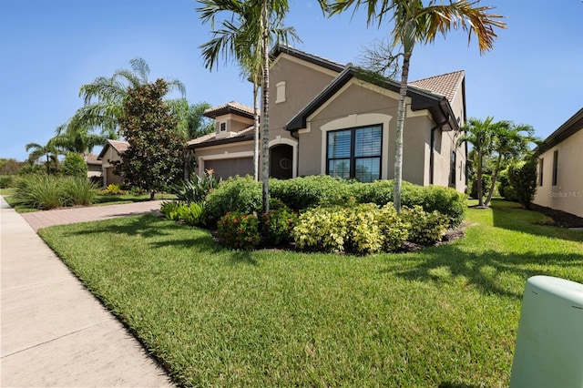 view of front facade with a garage and a front yard