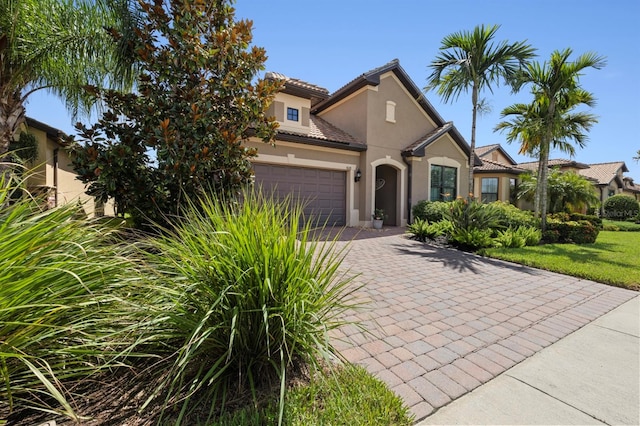 mediterranean / spanish-style home with a garage