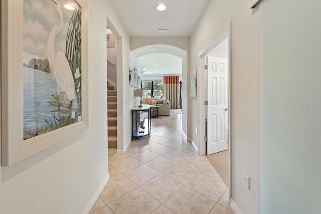 corridor featuring light tile patterned floors