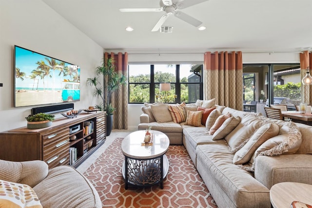 carpeted living room with ceiling fan