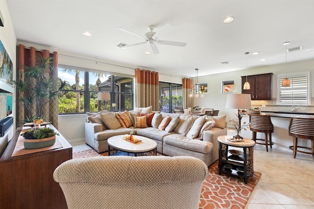 living room with ceiling fan and light tile patterned floors