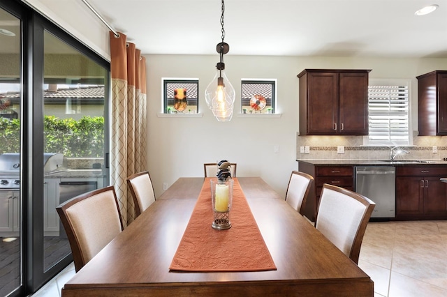 tiled dining space featuring sink and a healthy amount of sunlight