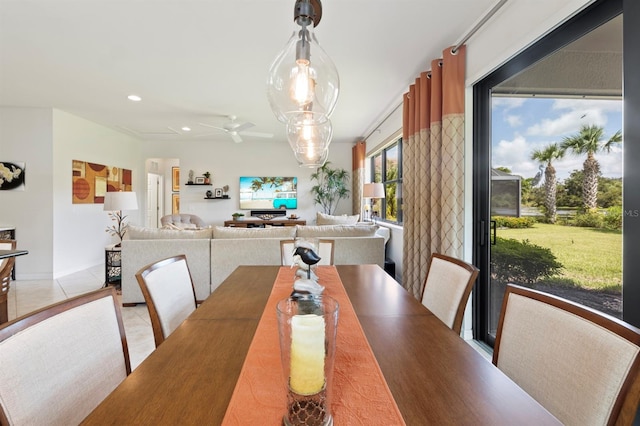 dining space featuring light tile patterned floors and ceiling fan