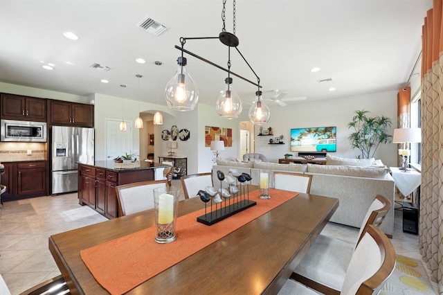 tiled dining room with ceiling fan