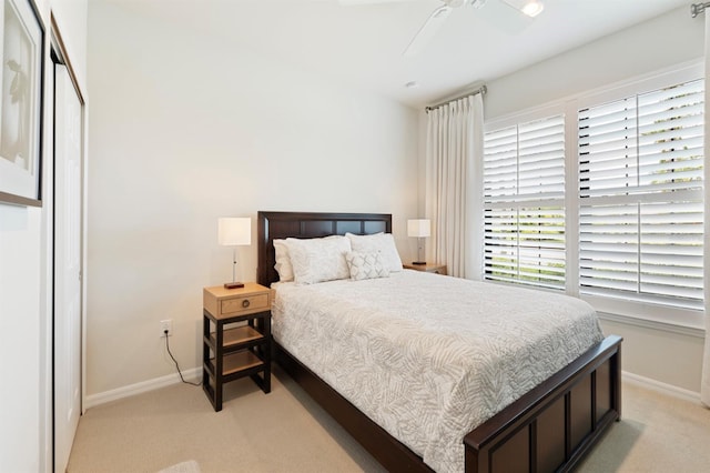 bedroom featuring ceiling fan and light carpet