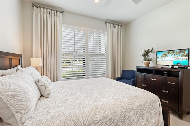 bedroom featuring ceiling fan and light carpet