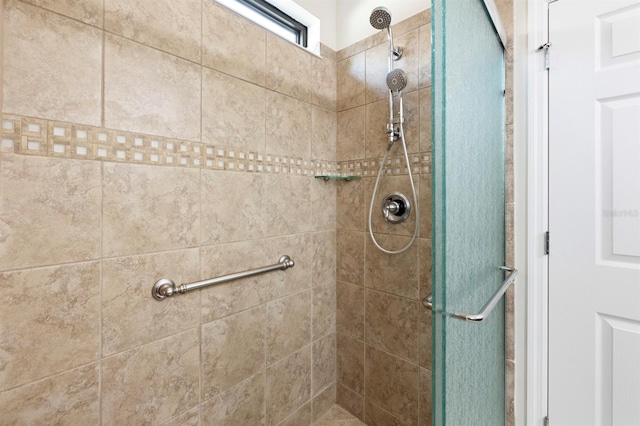 bathroom featuring a shower with door