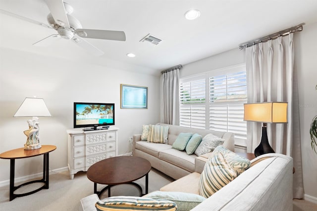 carpeted living room with ceiling fan