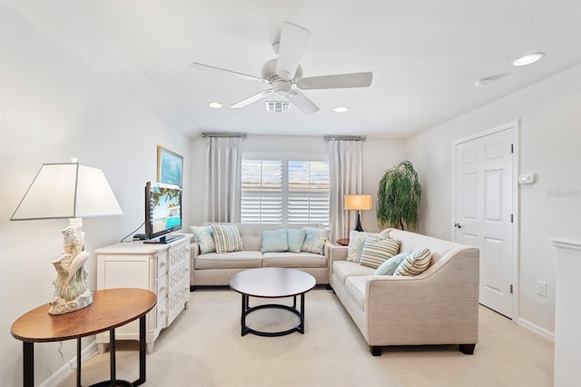 living room featuring light carpet and ceiling fan