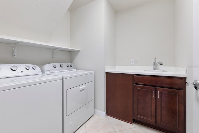 clothes washing area with sink, independent washer and dryer, and light tile patterned flooring